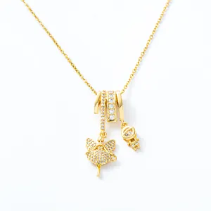 Chic gold necklace featuring fairy and astronaut charms with sparkling crystal accents