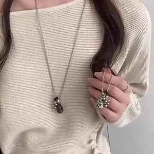 Elegant long sweater necklace with tiger eye and dalmatian jasper teardrop pendants