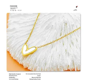 Macro detail of 18K gold plated heart necklace featuring white mother of pearl inlay