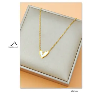 Detail of a heart-shaped mother of pearl pendant on a gold stainless steel chain
