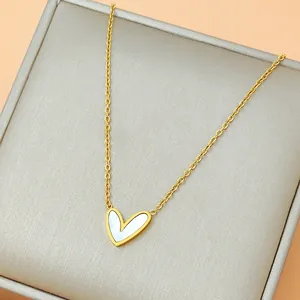 Gold stainless steel heart necklace with white mother of pearl inlay on gray jewelry box