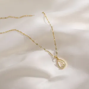 Elegant gold tulip pendant necklace with cat eye opal and zircons on white silk
