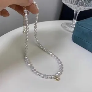 Elegant French vintage white pearl necklace with gold bead accent and lobster clasp