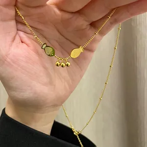 Golden titanium steel necklace with double fish pendant and delicate bead chain