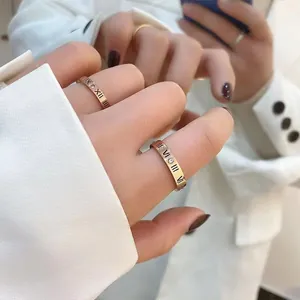 Elegant rose gold Roman numeral rings with crystal accents for women on a model hand