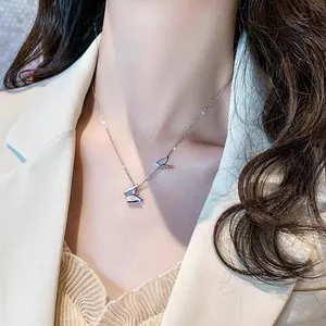 Detail of silver double butterfly pendant necklace on collarbone with mother of pearl inlay