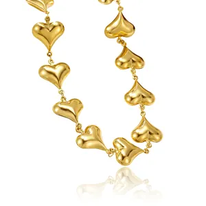 Detailed macro view of 3D gold linked hearts on a stainless steel luxury necklace