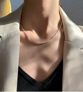 Detail of shimmering silver titanium steel chain showing the sparkling texture on a model