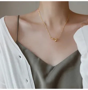 Detailed view of elegant gold bamboo pendant necklace worn on neck for a luxury look