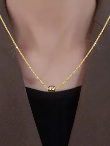 Detailed view of shiny gold ball pendant on sparkling starry chain necklace for women