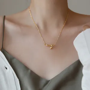 Titanium steel bamboo joint necklace with gold pendant for women on a model