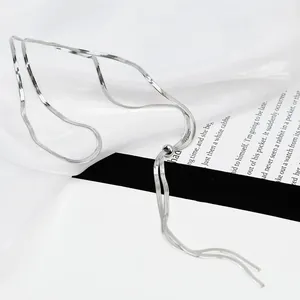 Detail of silver flat snake chain with adjustable ball slide and tassel design