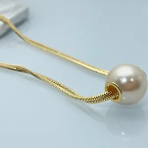 Elegant gold snake chain necklace featuring a large lustrous cream pearl pendant