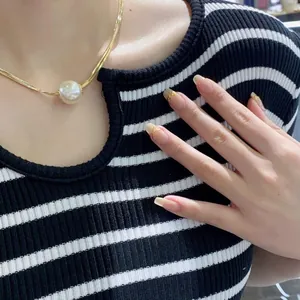 Elegant gold flat snake chain necklace featuring a large pearl pendant for women
