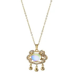 Golden titanium steel Ruyi lock necklace with iridescent stone and tassels on white background