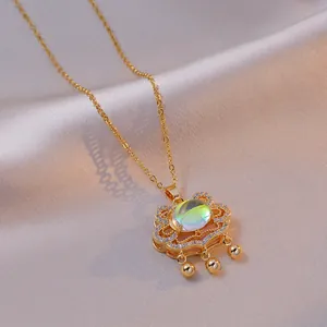 Elegant gold Ruyi lock necklace with iridescent gemstone and zircon inlay on silk background