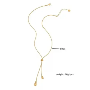 Close-up of gold Y-shaped snake chain necklace with teardrop pendants and 50cm size detail