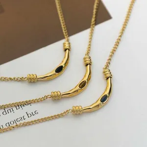 Three vintage gold titanium steel necklaces with organic tube pendants and tiger eye stones