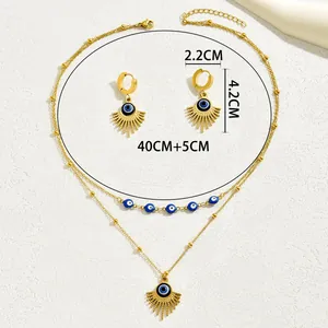 Bohemian gold Evil Eye jewelry set with layered sunburst necklace and dangle earrings