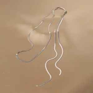 Detail of silver snake bone chain necklace with adjustable sliding bead on satin fabric