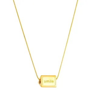 Golden titanium steel necklace with a minimalist cube pendant engraved with smile