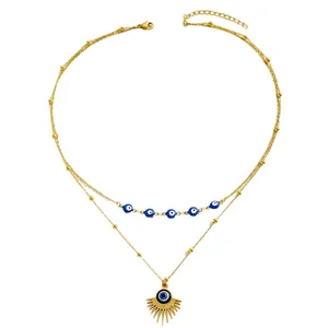 Bohemian gold layered necklace featuring evil eye charms and sun ray pendant detail