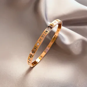 Poliertes Armreif aus Titan in Roségold mit römischen Ziffern und runden Kristallen