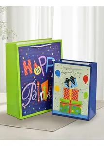 Detailed view of colorful Happy Birthday dinosaur gift bags with white rope handles