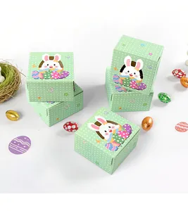 Close-up of green polka dot Easter bunny gift boxes with colorful egg decorations