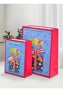 Detailed view of pink birthday gift bags with happy birthday tag and 3D gift box design
