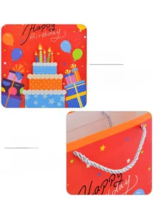 Detail of red Happy Birthday gift bag featuring 3D cake design and woven rope handles