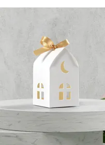 White house-shaped gift box with hollow moon cutout and elegant golden ribbon