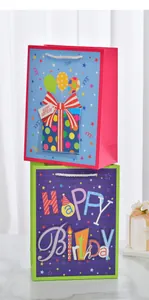 Detailed view of colorful Happy Birthday gift bags with gold glitter and 3D patches