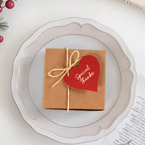 Red heart-shaped Special Thanks gift tags on a kraft paper box tied with jute twine