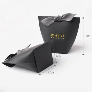 Elegant black paper gift box with grey satin ribbon and gold foil Merci Beaucoup text