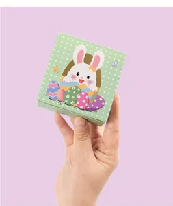 Close-up of green polka dot Easter gift box with cute bunny and egg illustration