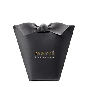 Elegant black gift box with grey satin bow and gold merci beaucoup inscription