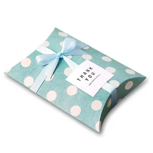Detailed view of blue polka dot pillow gift box with light blue silk ribbon and thank you card