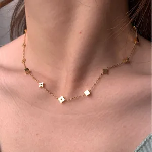 Elegant gold four-leaf clover titanium steel necklace with small geometric charms for women