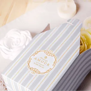 Detail of striped gift box with gold foil logo and elegant French typography pattern