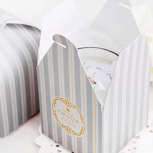 Elegant grey striped gift box with gold foil accents featuring a scented candle inside
