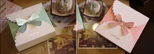 Detailed view of gift boxes with decorative bow and Thank You text in mint and pink
