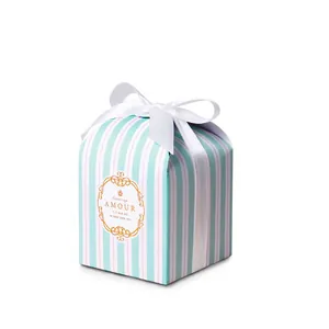 Elegant blue and white striped gift box with white satin bow and gold foil accents