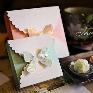 Pink and teal envelope gift boxes with large bows and gold Thank You lettering