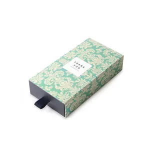 Scatola regalo a cassetto verde vintage con nastro blu e etichetta di ringraziamento