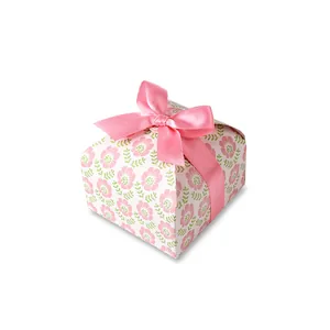 Floral paper gift box with pink flower pattern and a decorative satin ribbon bow