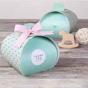 Detail of mint green candy gift box with pink ribbon bow and floral geometric patterns
