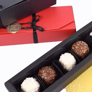 Red and black rectangular chocolate gift boxes with ribbons and gold seals on white background