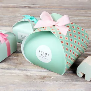 Detail of mint green wedding gift box with floral sleeve and a satin ribbon bow
