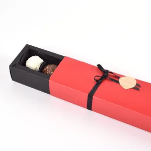 Elegant red and black drawer-style chocolate gift box with ribbon and gold tag